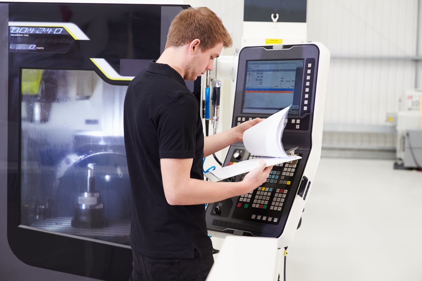 CNC engineer checking a production programme