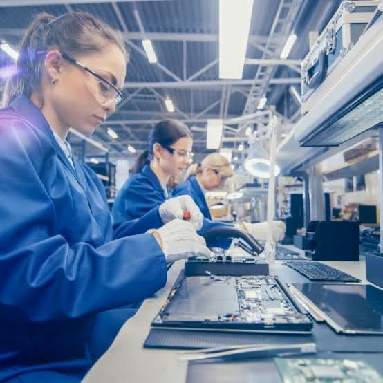 Electronics technicians assembling devices