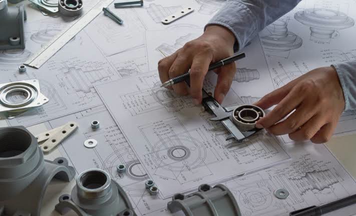 Mechanical engineer measuring a bearing on a technical drawing